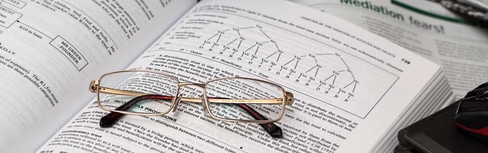Pair of glasses sitting on an open book
